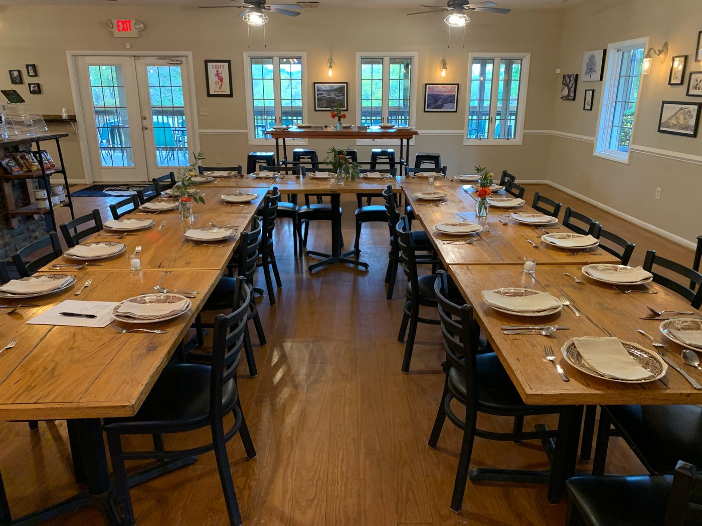 A private dining room with farmhouse tables set for a dinner