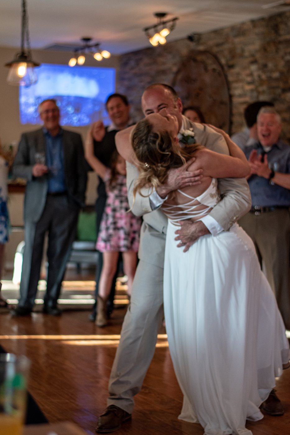 Newlyweds share a first dance as guests cheer