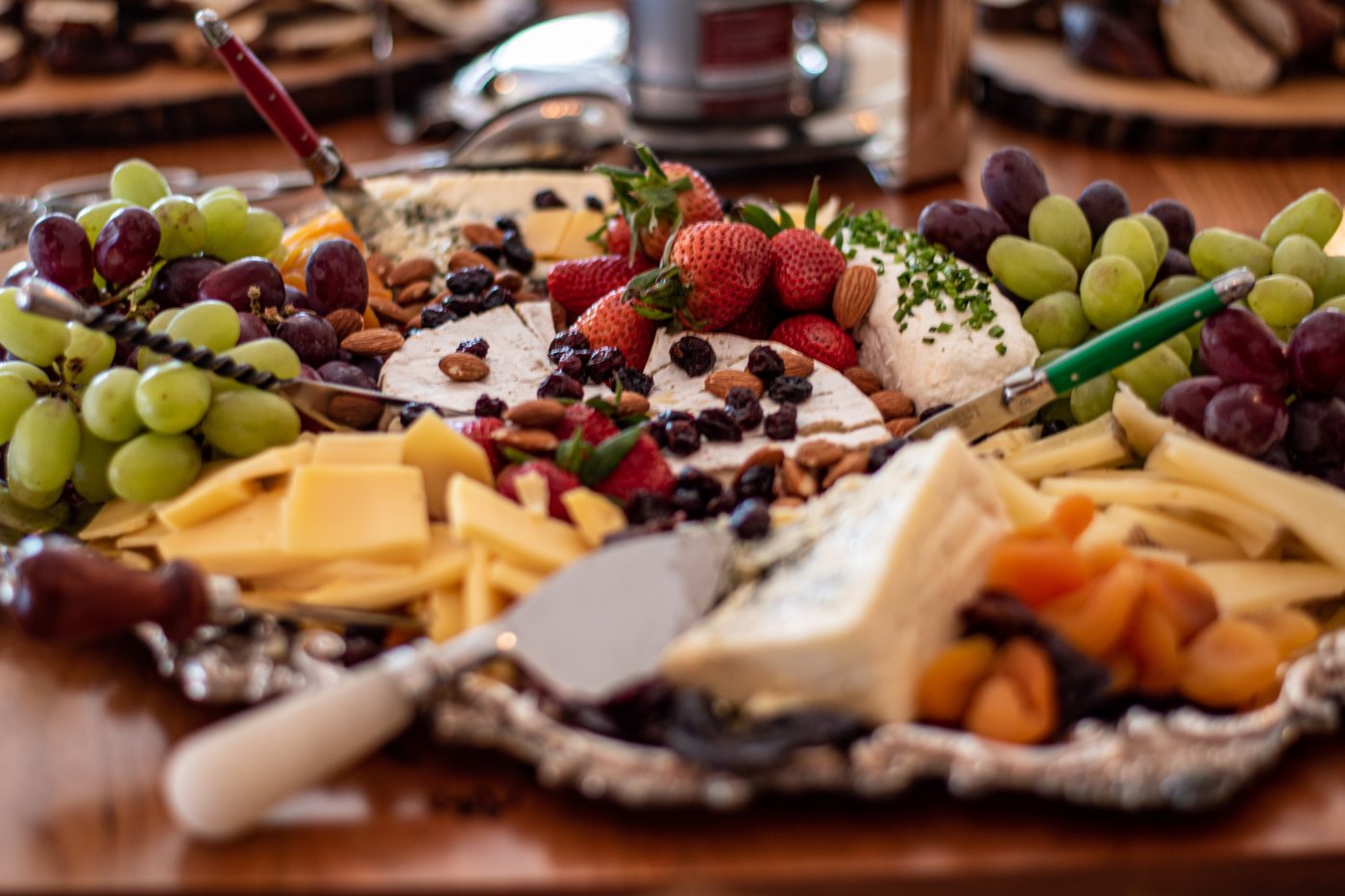 A grazing board with cheeses, fruit, and almonds